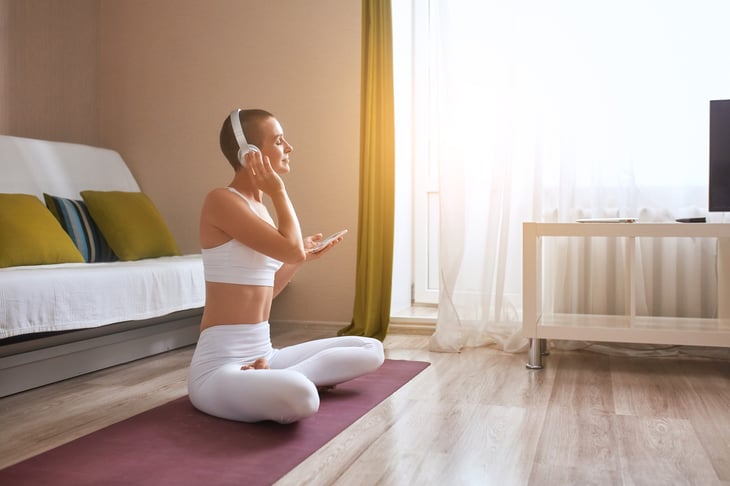 woman sitting on a yoga mat