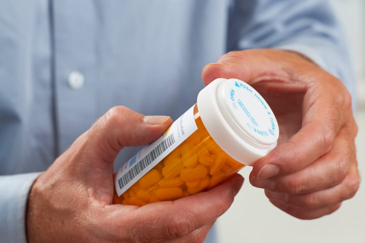 Patient holding a prescription pill bottle