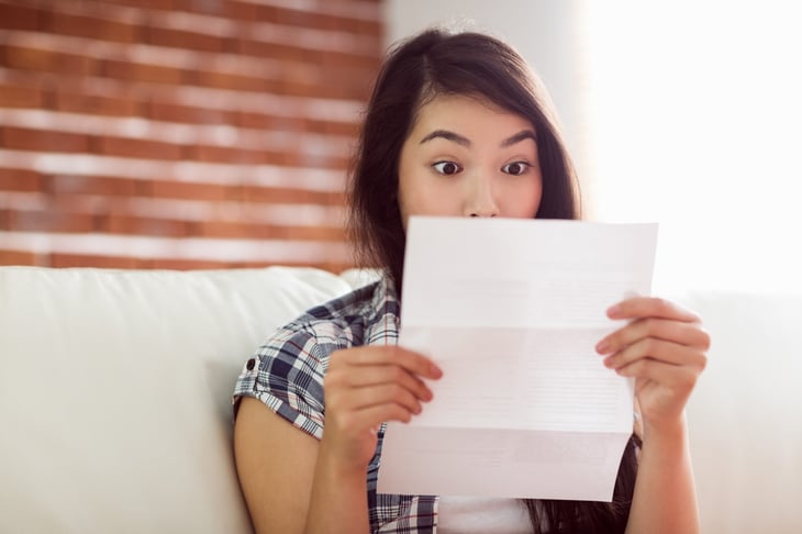 Surprised woman reading a letter