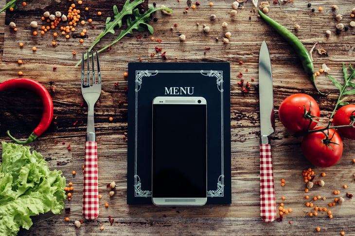 Using a smartphone to look up online menus for restaurants
