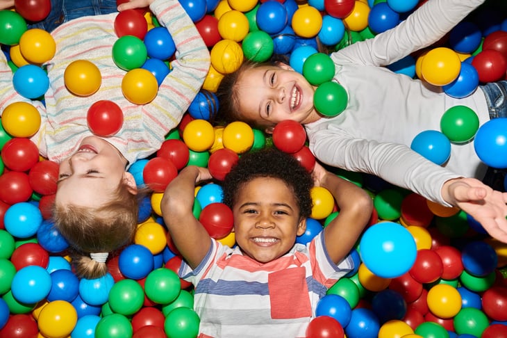Children playing in a colorful ball pit