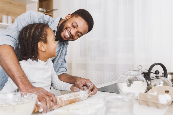 Father and child baking together