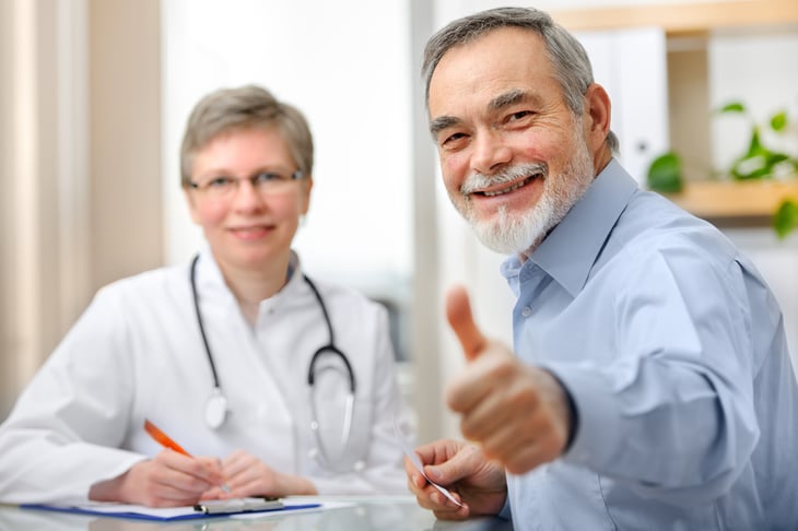 Happy senior patient with a doctor
