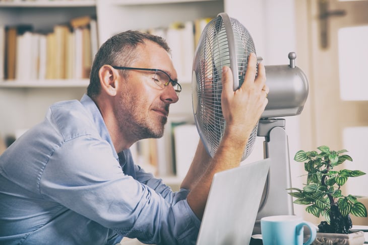 man trying to stay cool in summer heat