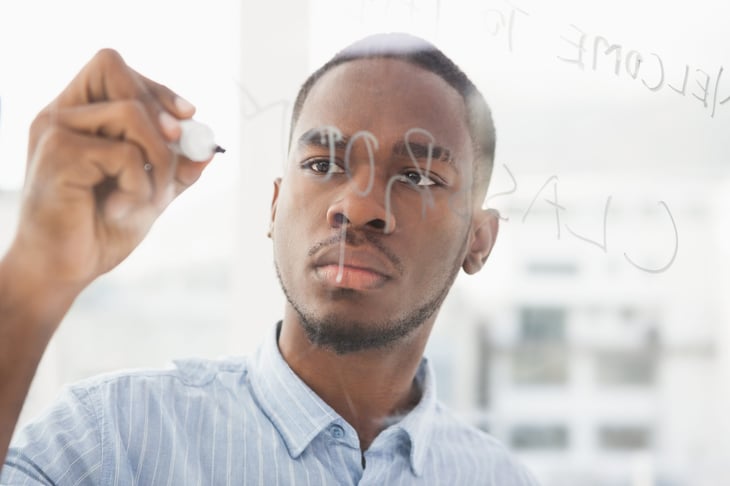 businessman writing on a marker board