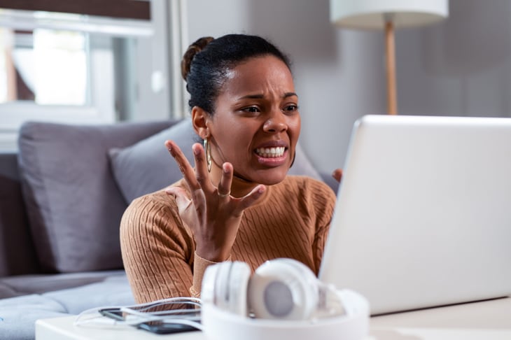Upset woman using a laptop computer