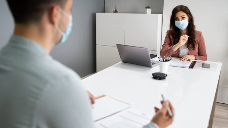 People in masks at a job interview during the coronavirus pandemic