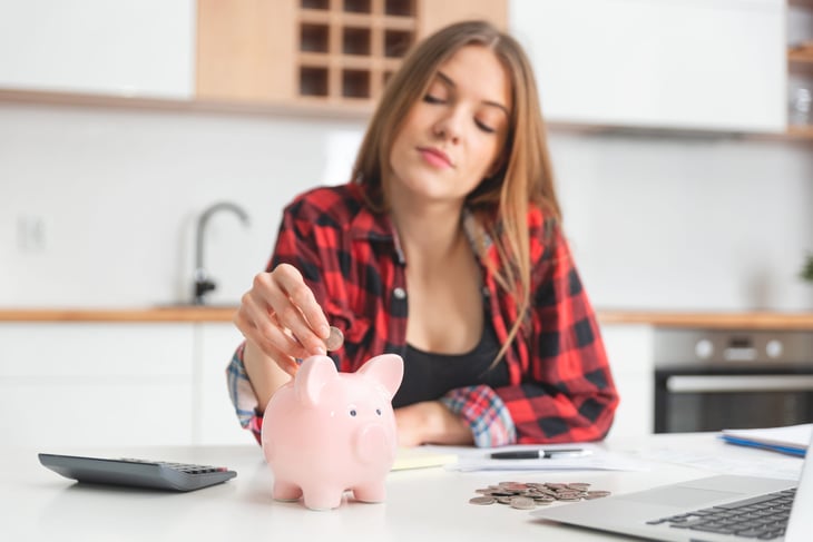Woman saving money in a piggy bank