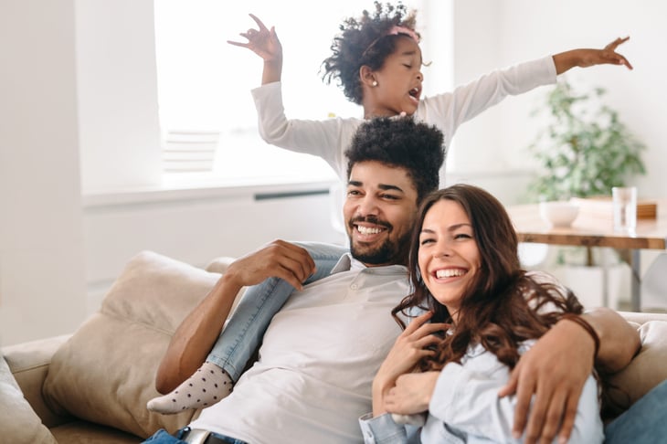A family sits together smiling