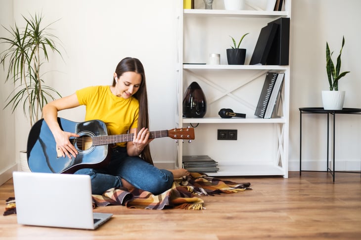 Woman playing a guitar for fun