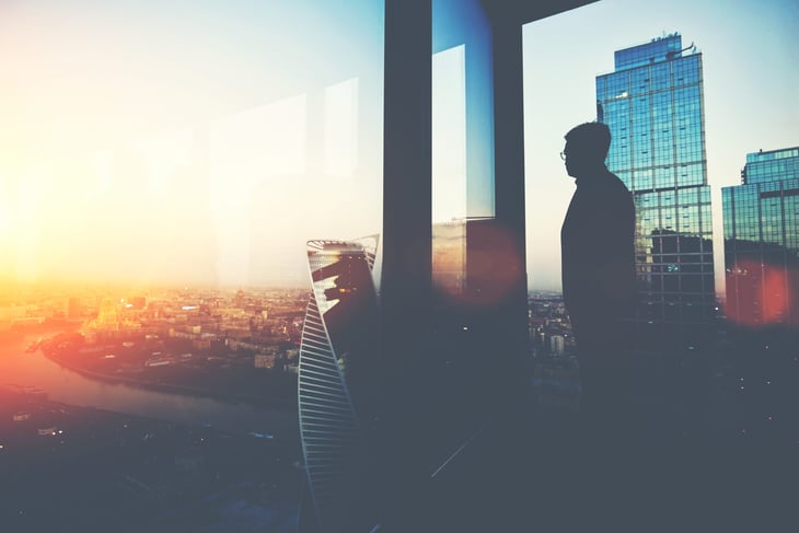 Wealthy investor looking out over city