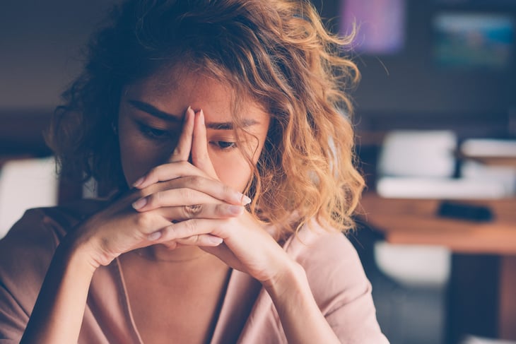 Sad, stressed woman at work