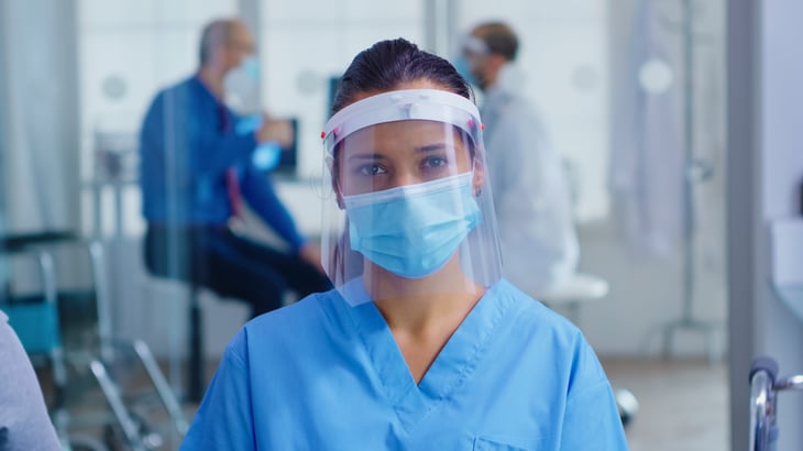 Health care worker in a mask and face shield
