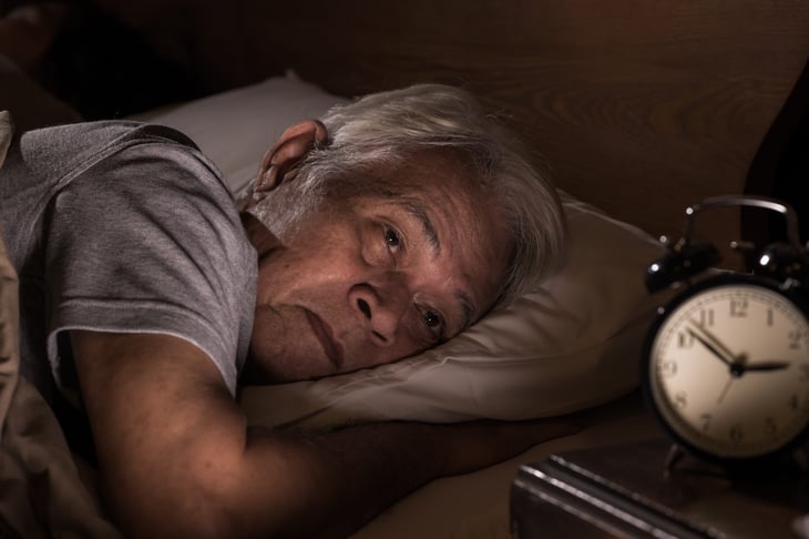Older senior man can't sleep because of retirement stress