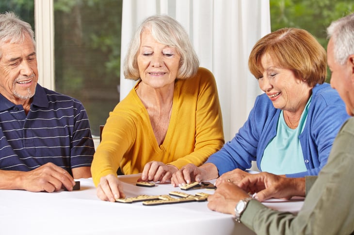 Seniors playing dominoes in a retirement home