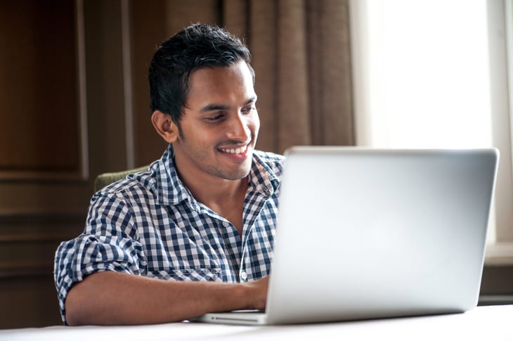 Young man working remotely on a laptop