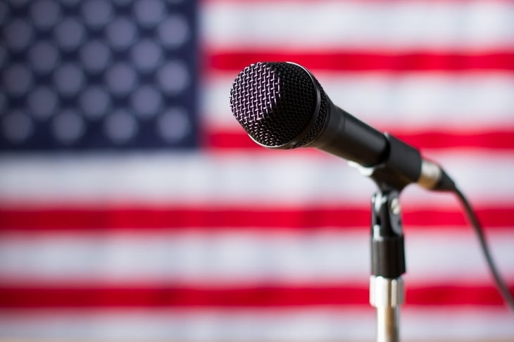 Microphone in front of a flag