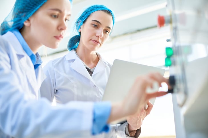 Female lab technicians operating machinery