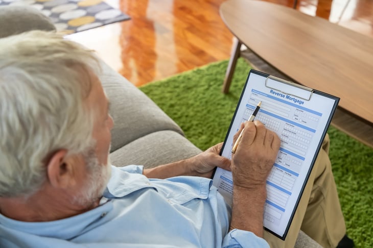 Senior man filling out a reverse mortgage application