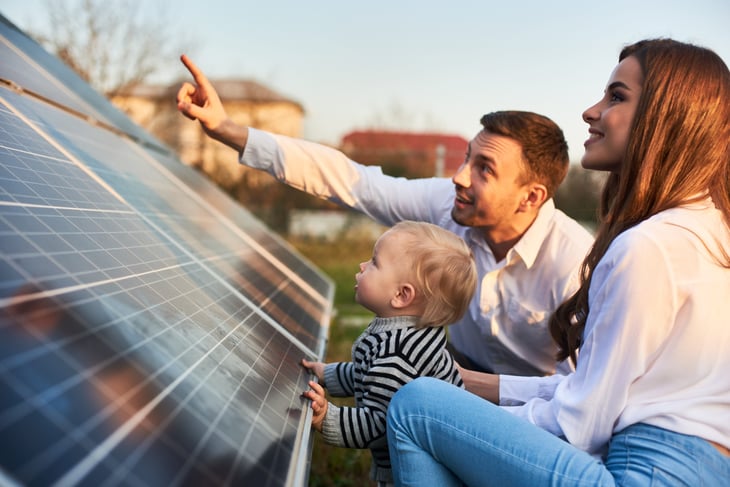 Family looking at solar panels for home solar energy