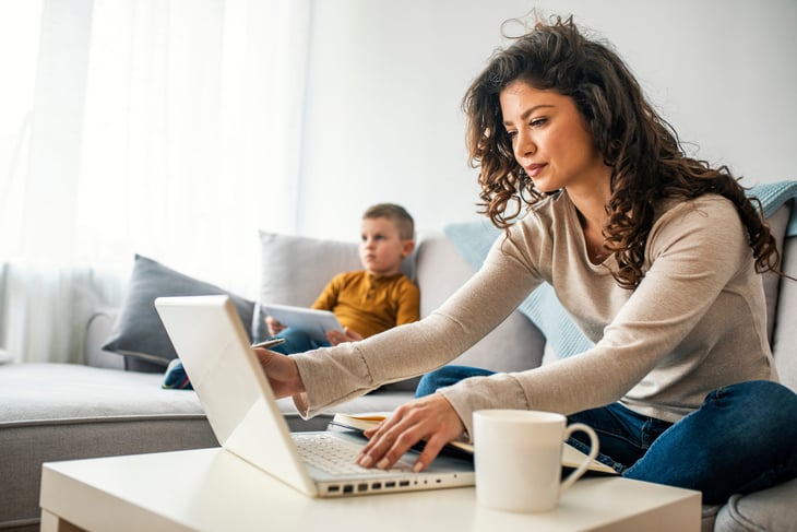Mother works from home on laptop