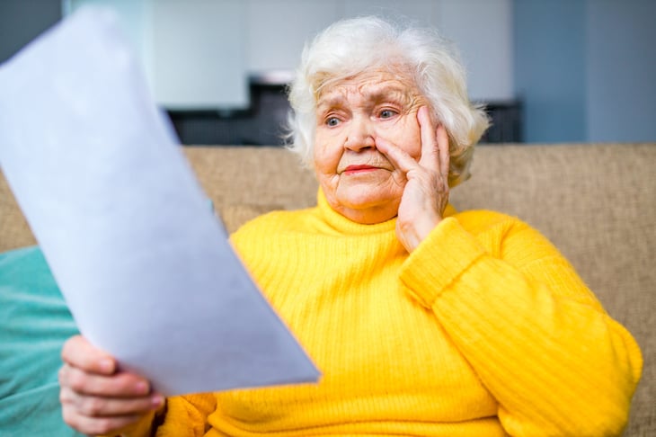 Upset senior worrying over a document