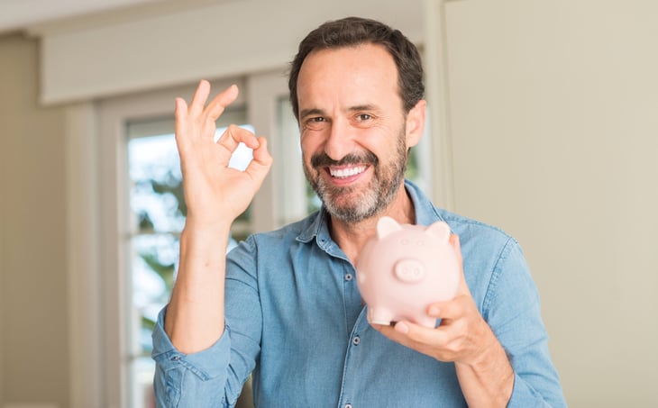 Excited man with piggy bank