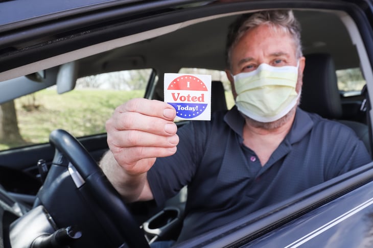 Man in a face mask after voting
