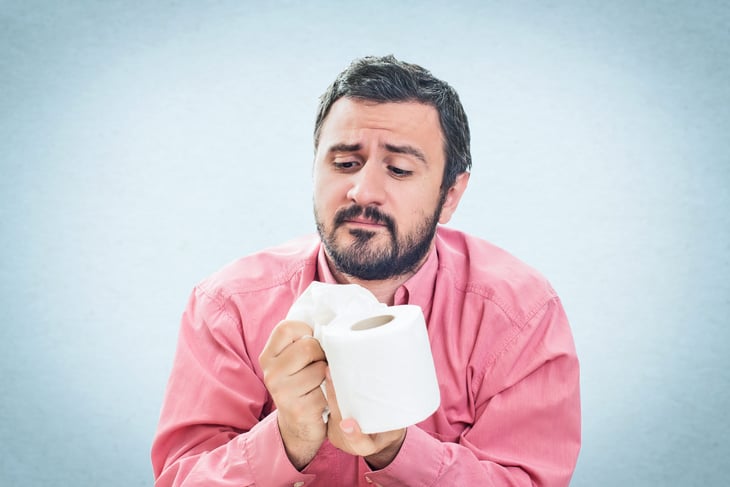 Man with roll of toilet paper