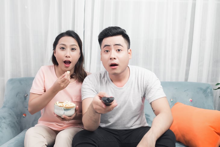 Unhappy couple watching TV