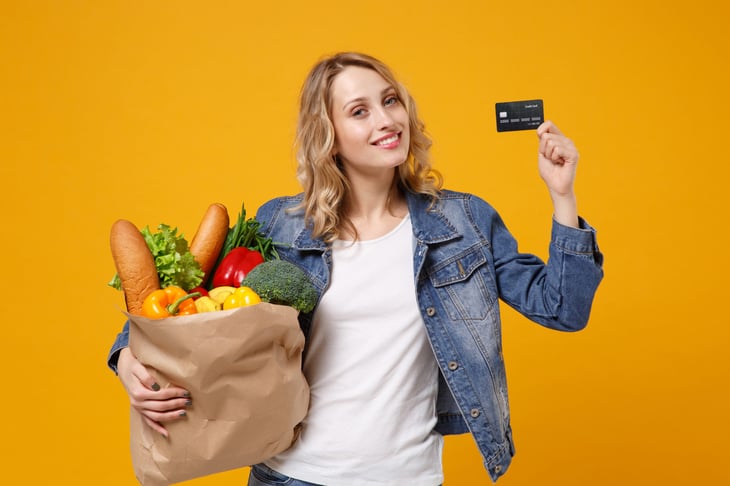 Woman excited about her groceries and credit card rewards