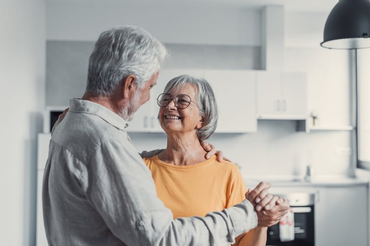 Happy older couple dancing in the kitchen