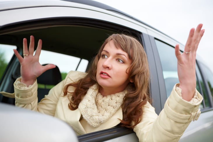 woman in car frustrated by bad driver