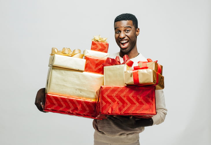 Man holding holiday gifts