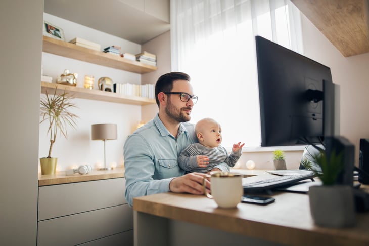 remote worker at desk with baby