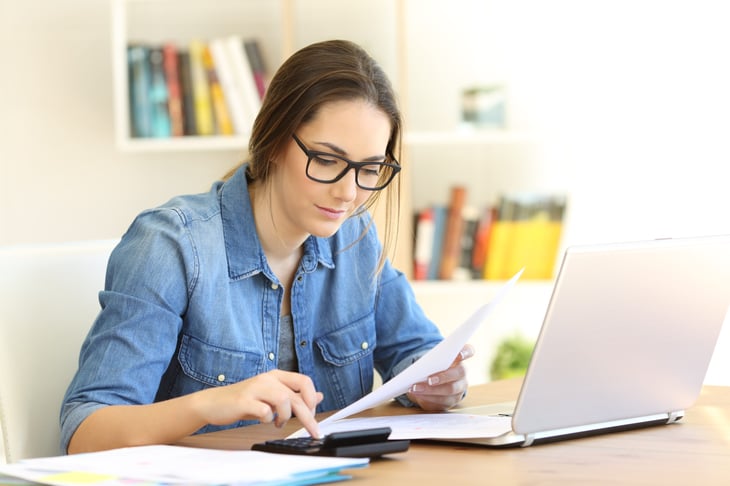 Woman doing taxes on laptop