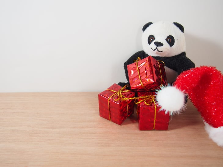 Stuffed panda bear with holiday gifts