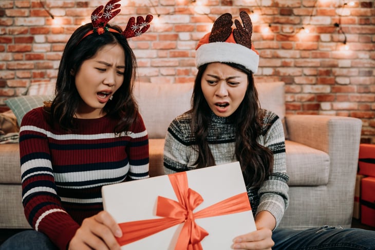 Upset women opening a bad present