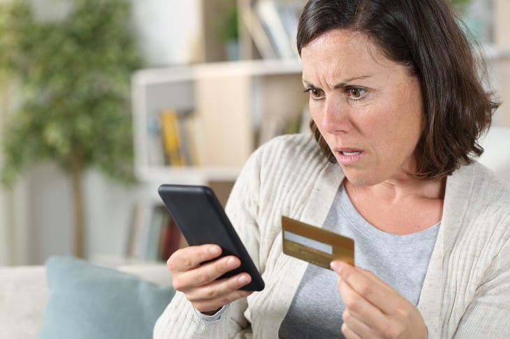 Upset woman with gift card