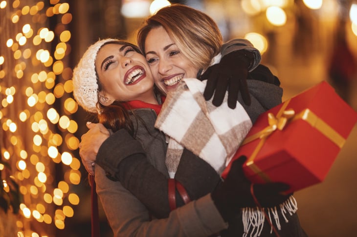 Women exchanging holiday gifts