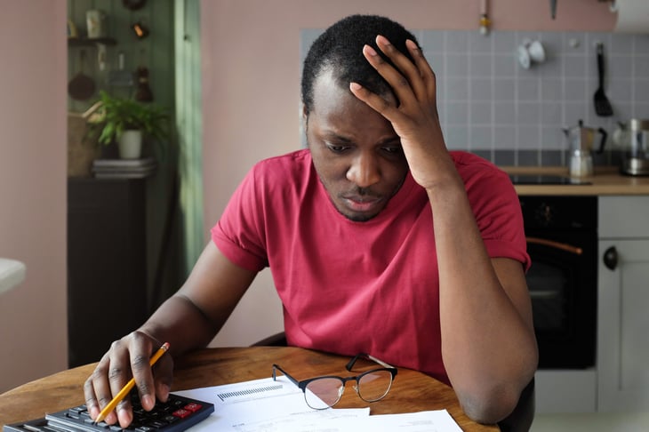 student debt loans man distraught distressed