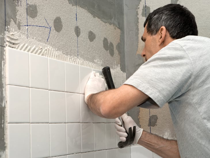 Man installing bathroom tile