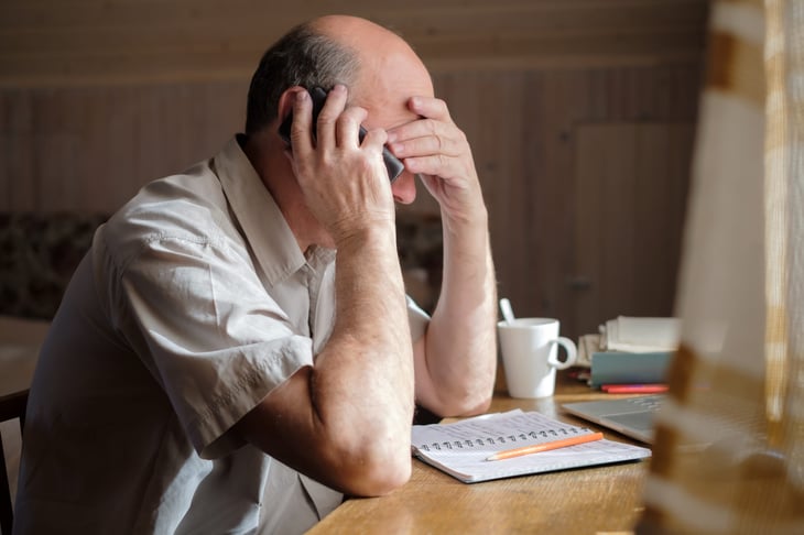 Upset investors talking on the phone