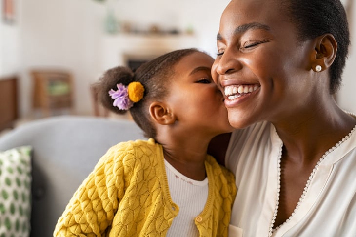 Daughter kissing her mother