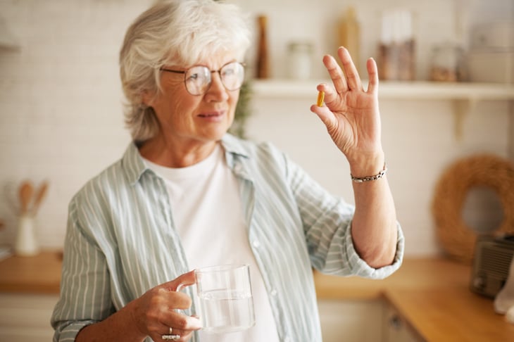 Woman holding a multivitamin