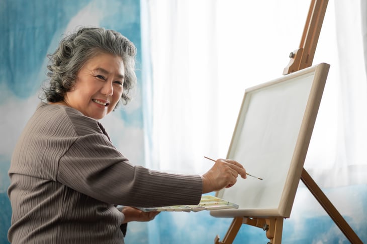 Senior woman learning to paint