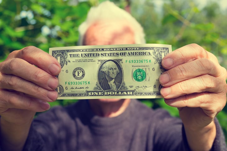 Older man with dollar bill
