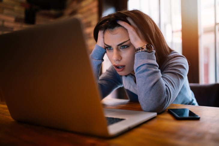 Upset woman using a laptop computer