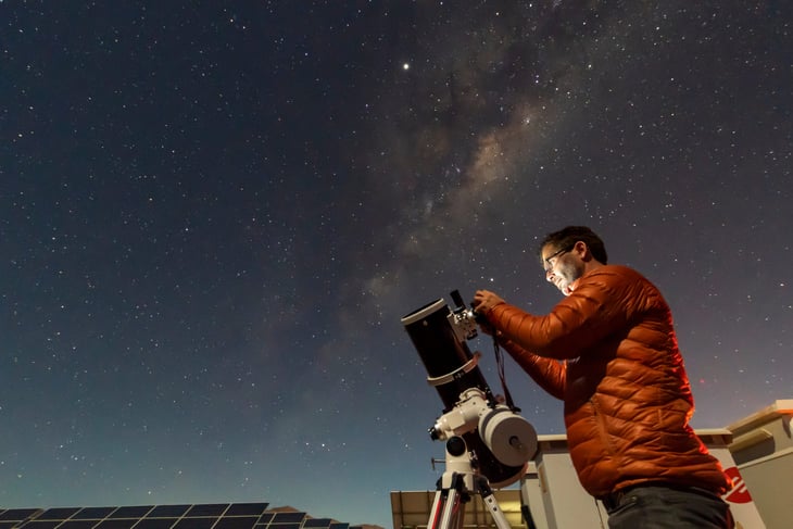 Astronomer looking through a telescope at the stars