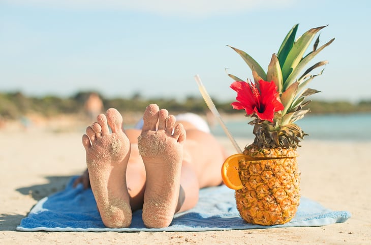 Sunbather on the beach with a drink